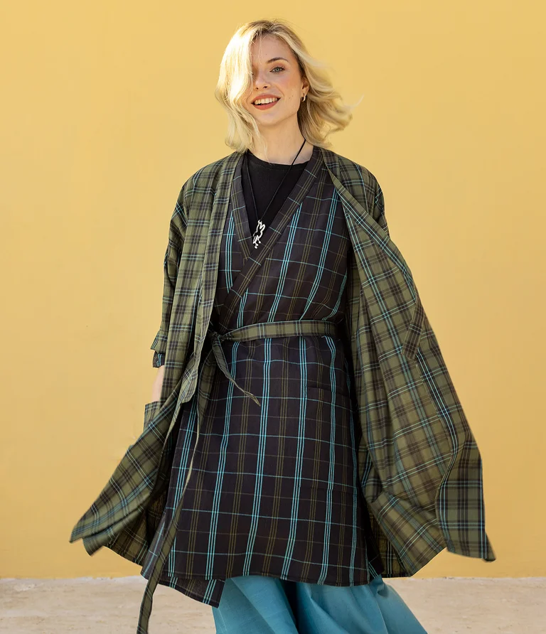 A woman wearing a checked kimono from Gudrun Sjödén.