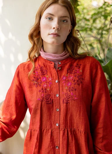 A woman wearing a red dress from Gudrun Sjödén. 