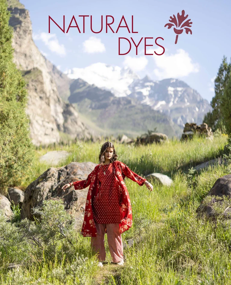 A woman wearing a patterned dress and an open wrap dress from Gudrun Sjödén.