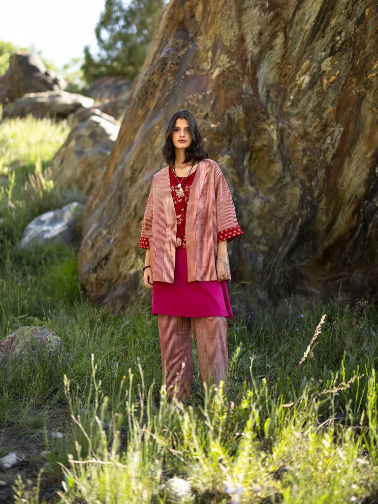 A woman wearing patterned clothing from Gudrun Sjödén. 