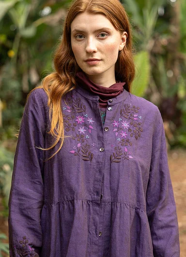 A woman wearing a purple dress from Gudrun Sjödén.