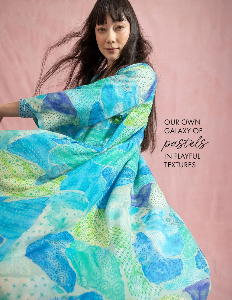 A woman wearing a patterned blue dress from Gudrun Sjödén. 