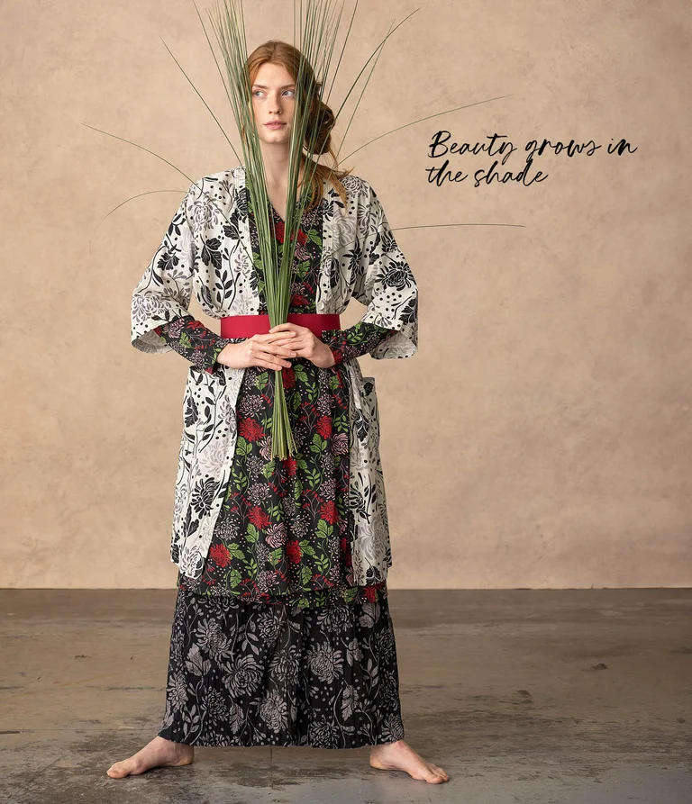 A woman wearing layers of patterned clothing from Gudrun Sjödén. 