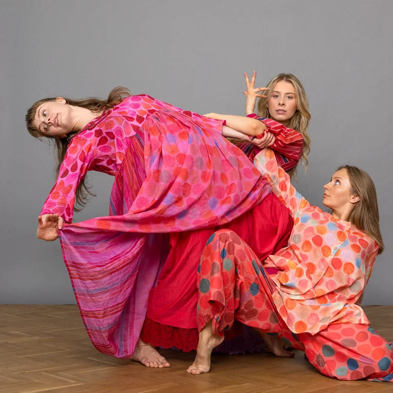 A picture of three women in a dance pose wearing clothes from Gudrun Sjödén’s Paris collection.