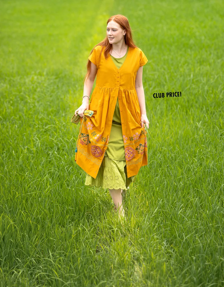 A woman wearing layers of clothing from Gudrun Sjödén.