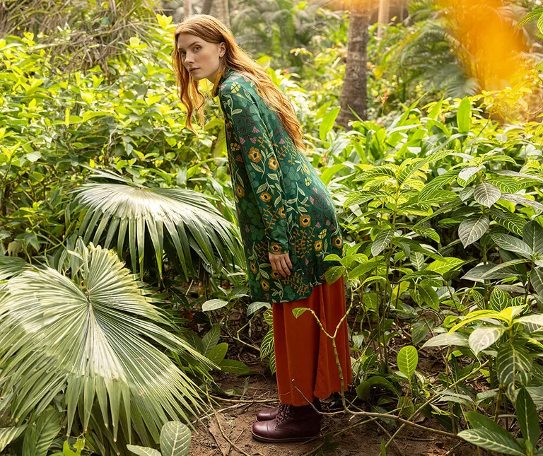 A woman wearing a patterned tunic from Gudrun Sjödén. 