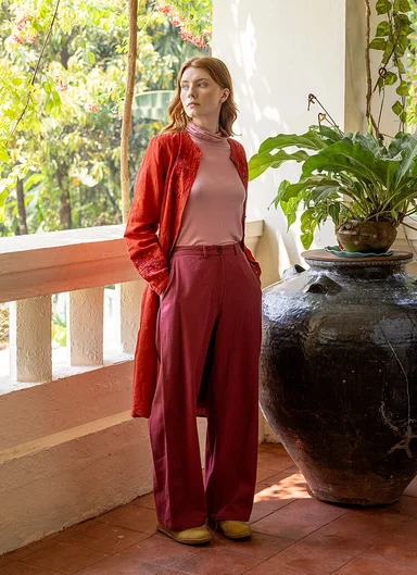 A woman wearing red trousers from Gudrun Sjödén.