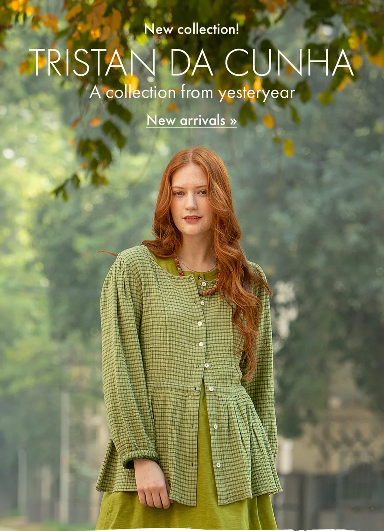 Photo of a woman in a natural, green setting wearing green clothes from Gudrun Sjödén’s 2025 Winter collection. 