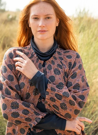 A woman wearing a patterned dress from Gudrun Sjödén. 