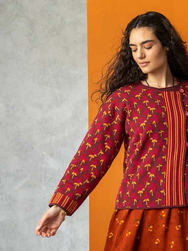 A woman wearing a floral cardigan from Gudrun Sjödén.