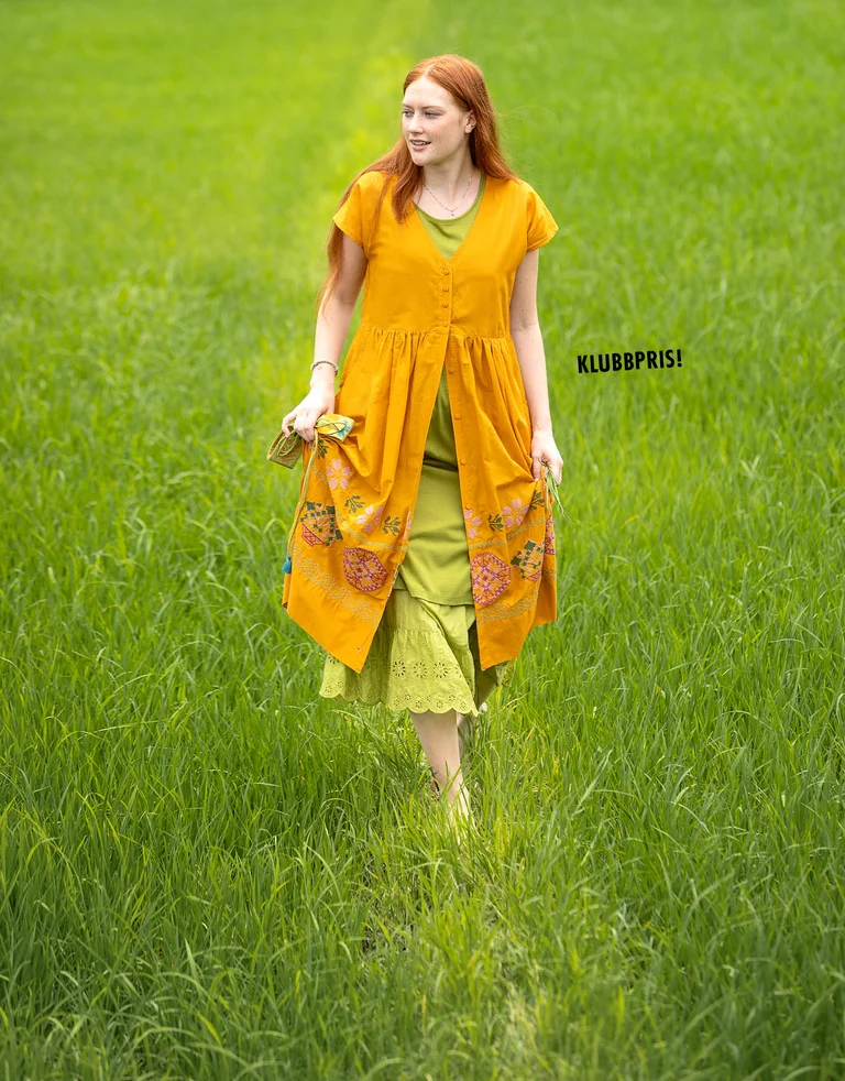 A woman wearing layers of clothing from Gudrun Sjödén.