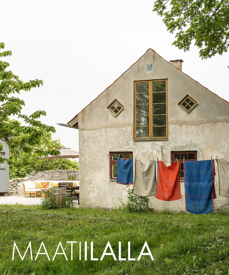 A lime-plastered house on Gotland with home textiles from Gudrun Sjödén on a clothesline.