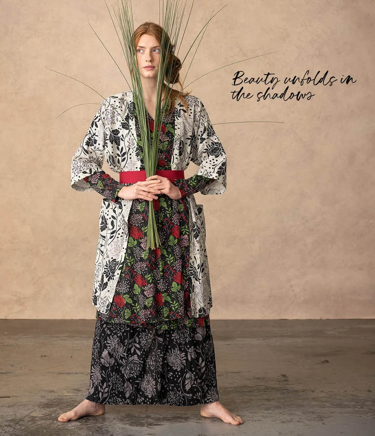A woman wearing layers of patterned clothing from Gudrun Sjödén. 