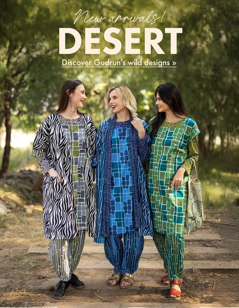 Three women standing next to each other outdoors wearing patterned clothes from Gudrun Sjödén.