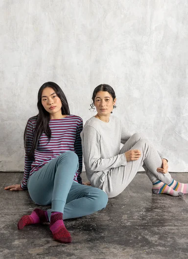 A woman wearing a striped jersey top from Gudrun Sjödén.