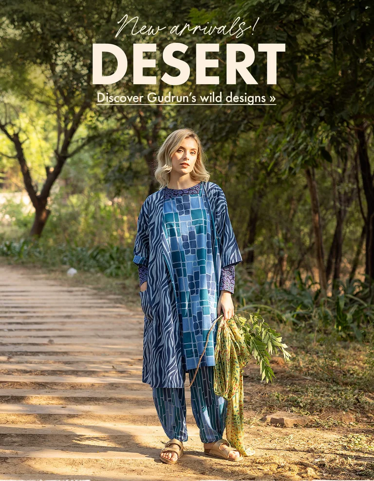 Three women standing next to each other outdoors wearing patterned clothes from Gudrun Sjödén.