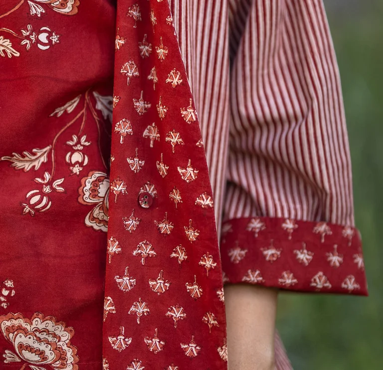 A close-up of a red, block-printed garment from Gudrun Sjödén.