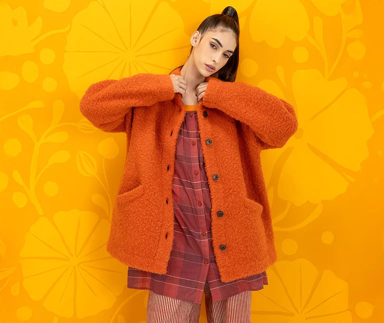 A large collage with multiple pictures of women wearing clothes in shades of blue and purple from Gudrun Sjödén.