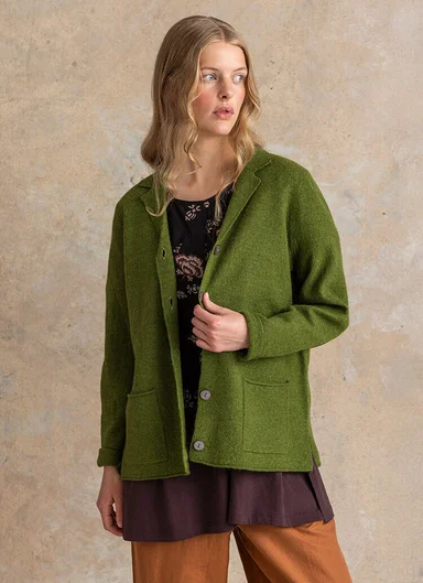 A woman wearing red and pink knitwear from Gudrun Sjödén.