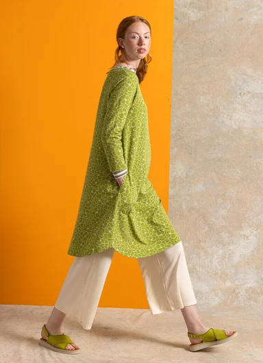 A woman wearing a red jersey dress from Gudrun Sjödén.