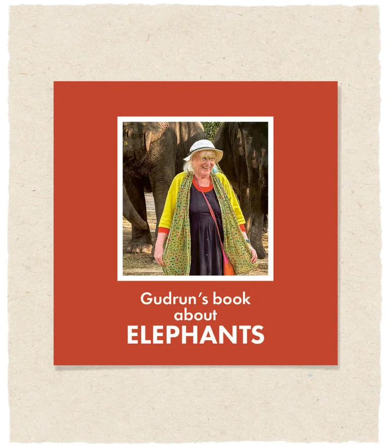 The cover of Gudrun Sjödén’s book about elephants, featuring Gudrun herself smiling in front of two elephants.